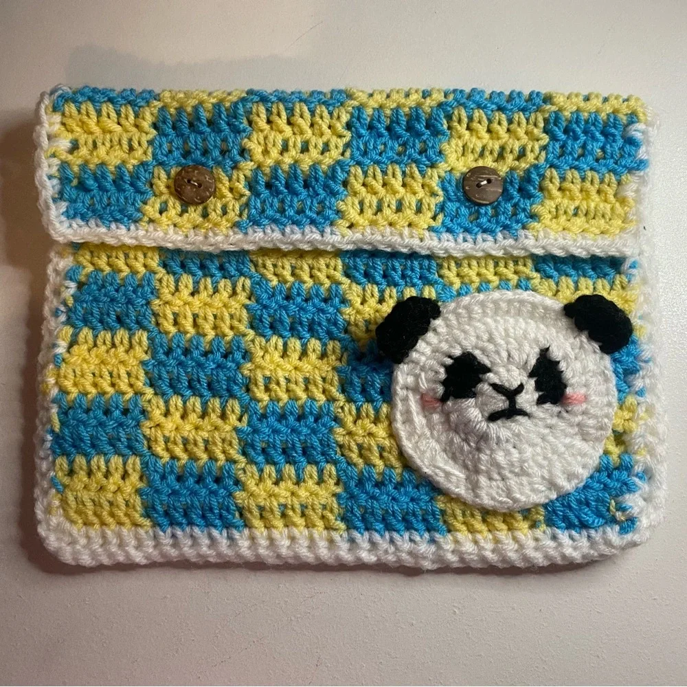 Crochet tablet/book sleeve in Blue and Yellow with small panda pocket.